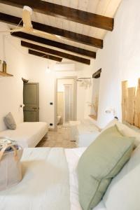 a white bedroom with two beds in a room at Agriturismo Alveare in Finale Ligure