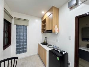 a small kitchen with a sink and a counter at Uh Homestay Thảo Điền in Ho Chi Minh City