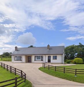 a white house with a fence in front of it at Sperrin View in Omagh