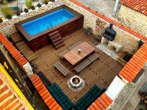 an overhead view of a swimming pool on a wooden deck at El nido del Mirlo in Casarejos