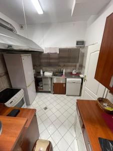 a kitchen with stainless steel appliances and a tiled floor at Willa Sarenka in Radzyń