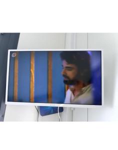 a television screen with a picture of a man at Pas Alksnius in Rotuliai