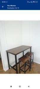 a table with a bench and a table and stool at Pas Alksnius in Rotuliai +4 photos