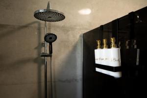 a shower with a shower head in a bathroom at Luxury Opus Osijek - Self Check in, Free Private Parking in Osijek +187 photos