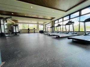 a gym with a row of treadmills and machines at Verdon Parc Butterfly Haven in Davao City