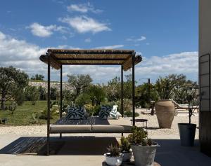 a bed with pillows on it in a garden at Papalei La Maison in Ragusa