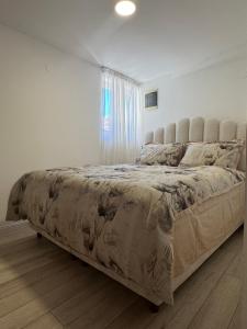 a large bed in a bedroom with a window at Mille in Igalo
