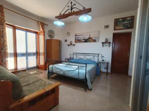 a bedroom with a bed and a couch at Villa Panorama in Lipari