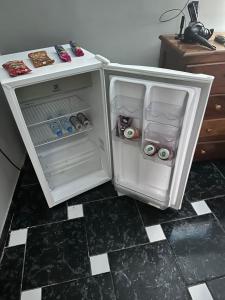 a small refrigerator with its door open in a kitchen at Villa Serena in Castanhal
