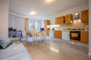 a kitchen with a couch and a table in a room at Discover Tortoreto in Tortoreto Lido