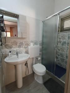 a bathroom with a toilet and a sink and a shower at Villa Panorama in Lipari