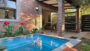 a swimming pool in front of a house at Khaya Kwalata in Marloth Park