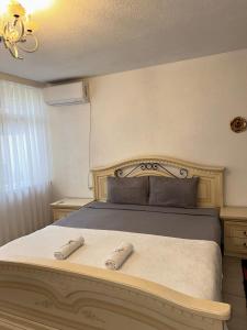 a bedroom with a bed with two slippers on it at Prishtina Guests in Prishtinë
