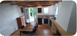 a kitchen with a wooden table and a dining room at Le cabanon in Valensole