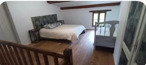 a bedroom with a bed and a wooden floor at Le cabanon in Valensole