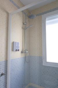 a shower in a bathroom with blue tiles at Paseo Imperial in Arcos de la Frontera +44 photos
