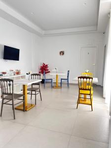 a room with chairs and a table and a tv at Blu Parthenope a Spaccanapoli in Naples