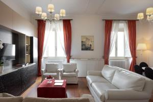a living room with a couch and a table at Altarocca Embassy Rome in Rome