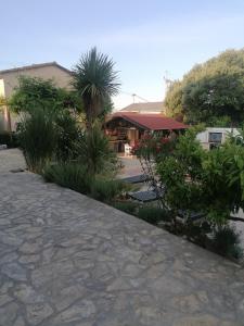 a walkway in front of a building with plants at Villa Olma in Okrug Gornji