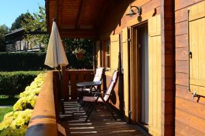 a patio with a table and an umbrella on a house at Blockhaus Rosa Reischl in Neubeuern