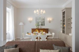 a living room with a table and a couch at Altarocca Embassy Rome in Rome +41 photos