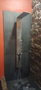 a black stall with a phone on a wall at Quinta Maravista in Faial da Terra +83 photos