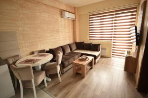 a living room with a couch and a table at Apartman Valentina Aqua Park in Jagodina