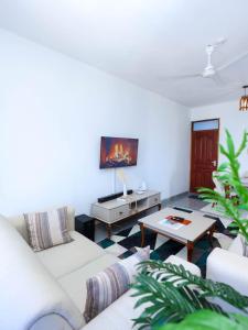 a living room with a couch and a table at Kenya coast stays in Nyali