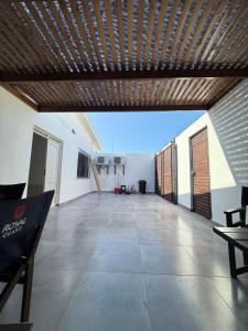a large empty room with a wooden ceiling at Casa Hostal , Mejillones in Mejillones