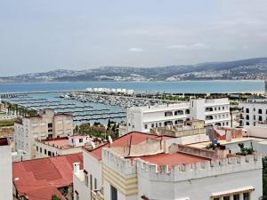 a view of a city with buildings and a body of water at El Muniria in Tangier
