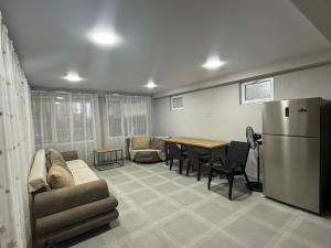 a room with a couch and a table and a refrigerator at Grigoleti Royal in Grigoleti