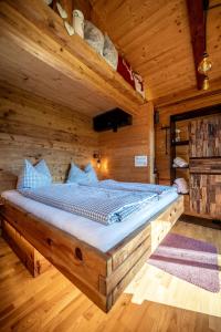 a bedroom with a bed in a wooden room at Tiny House Singer - contactless check-in - Sauna in Ehenbichl