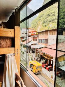 a view of a city from a window at Nativus Hostel Machu Picchu in Machu Picchu