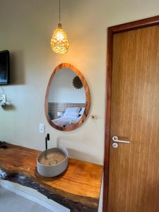 a bathroom with a sink and a mirror at Casa do Ney in Fernando de Noronha