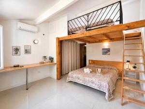 a bedroom with a bunk bed and a desk at Le Maquis Plage Corse in Poggio-Mezzana +101 photos