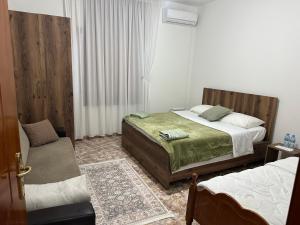 a bedroom with two beds and a chair in it at Hostel Rinas in Rinas