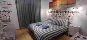 a bedroom with a bed with blue pillows on it at Alloggio del Pescatore e Alloggio del Marinaio con Piscina Palestra Jacuzzi Sauna - All Inclusive in Anzio +69 photos