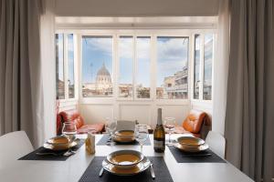 a dining table with a view of the capitol building at St Peter Lodge in Rome