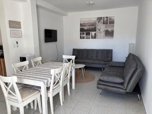 a living room with a table and a couch at Beach Apartments Luka in Tribanj-Krušćica