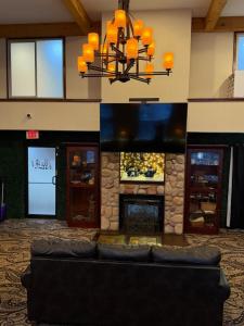 a lobby with a couch in front of a fireplace at White Pine Lodge in Salamanca