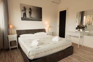 a bedroom with a bed and two tables and a mirror at St Peter Lodge in Rome