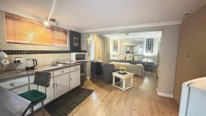 a living room with a kitchen and a living room with a bed at Artzy's Studio - 1km to Olivedale Clinic in Northriding +19 photos