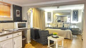 a living room with a bed and a living room with at Artzy's Studio - 1km to Olivedale Clinic in Northriding
