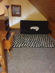 a bed in a room with a table and a chair at Le break vert in Lacapelle-Viescamp