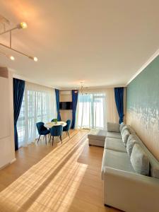 a living room with a couch and a table at Marconi Premium Apartments in Mamaia