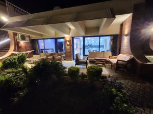 a living room with couches and chairs and windows at Cosy Romantic Sea View Villa at a 5 Hotel in Sharm El Sheikh +49 photos