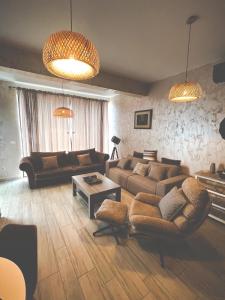 a living room with two couches and a table at Amare&Mare Apartment in Sutomore