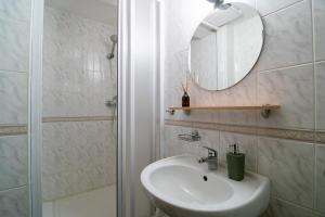 a bathroom with a sink and a mirror and a shower at Penzión Šafran Stratená in Stratená +17 photos