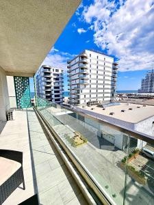 a view of a city from the balcony of a building at Marconi Premium Apartments in Mamaia