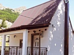 a small white house with a metal roof at Vikendica Ivanović in Prisoja